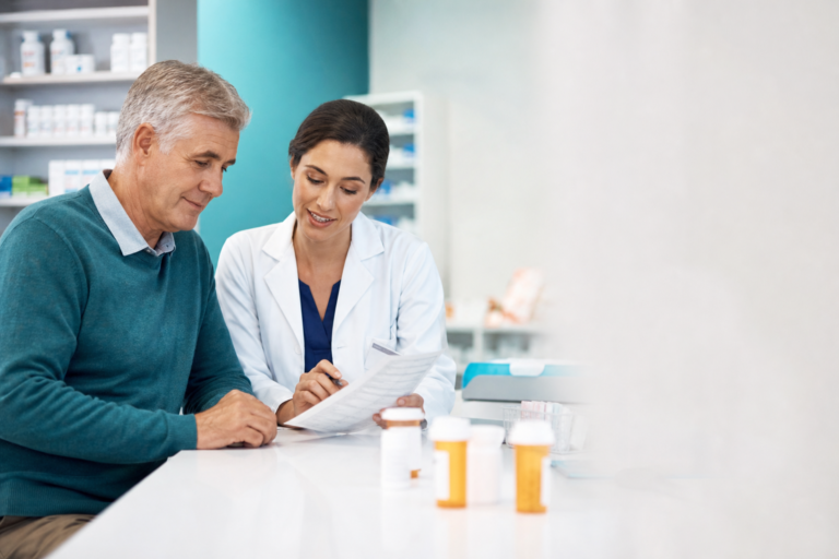 Adult turning 65 reviewing Medicare Part D prescription drug coverage with a pharmacist